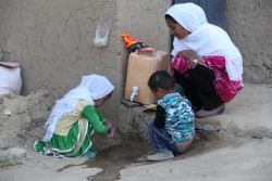 (Right) Mercia, 20, checks that her daughter Sohila, 5, (left) and son Alisina, 3, wash their hands properly outside their home in Chaw village, Nili district, Daikundi province, Afghanistan, Wednesday 1 November 2017. “The toilet was there but it wasn’t always used. This initiative helped us to realise that we should use it and to keep some soap nearby,” says Mercia. The district of Nili, in Daykundi province, central Afghanistan, was declared as the country’s first ‘open defecation free district’ at a ceremony on 1 November 2017. Towns and villages across Nili took on the ‘Community-led Total Sanitation’ approach in which families identify areas around their homes that are used as toilets. Through a combination of shock, shame, pride and disgust, families without a toilet decide to build their latrine. Community-wide commitment and some peer pressure does the rest and typically after three to six months an entire community has given up defecating in the open, contributing to a healthier environment for everyone.  The risks associated with diarrhoeal infections are exacerbated in Afghanistan – a country where some 1.2 million children are already malnourished and 41 per cent of children are stunted. Poor sanitation and hygiene compound malnutrition, leaving children more susceptible to infections that cause diarrhoea, which in turn worsens malnutrition.  In 2017, UNICEF in Afghanistan has already supported more than 500 Afghan communities to be declared and certified as open defecation free. Global research has shown that in some communities where people now use toilets rather than fields or other outside areas, stunting has been reduced by 23 per cent. Reducing cases of diarrhoea also cuts down on significant health costs that families face when having to treat their children for regular sickness.