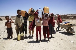 Children carry water containers in the Khamir IDP settlement, Amran Governorate, Yemen, Friday 14 April 2017. The landowners on which the IDP settlement is located recently turned off the main water supply, meaning residents have to walk long distances to fetch water. Since the start of 2017, the humanitarian situation in Yemen has substantially deteriorated. According to analysis by the Humanitarian Country Team released in April 2017, the number of people in need of assistance and protection is 20.7 million. Increasing tensions and hostilities in the western coast since January have left over 50,000 people displaced, many of them in locations where humanitarian access has been extremely challenging. Concerns regarding the continuity of operations of the Al Hudaydah port persist and the potential closure of the main port in Yemen would have significant consequences for the humanitarian operation. Between April and July 2017, 400,000 cases of suspected cholera and nearly 1900 associated deaths were recorded. Vital health, water and sanitation facilities have been crippled by more than two years of hostilities, and created the ideal conditions for diseases to spread. Nearly 2 million Yemeni children are acutely malnourished, which makes them more susceptible to cholera. Vital infrastructure, such as health and water facilities, have been damaged or destroyed by the conflict. Adding to the pressure on health services, more than 30,000 health workers have not been paid their salaries in more than 10 months. Yemen’s education system is also on the brink of collapse, and more than 5 million children risk being deprived of their right to education. As at June 2017, over 193,000 teachers have not received their salaries during the past nine months. Moreover, school infrastructure has been affected, with 222 incidents of attacks on schools documented and verified by the Country Task Force on Monitoring and Reporting of Grave Child Rights Violations (CTF MR) between M